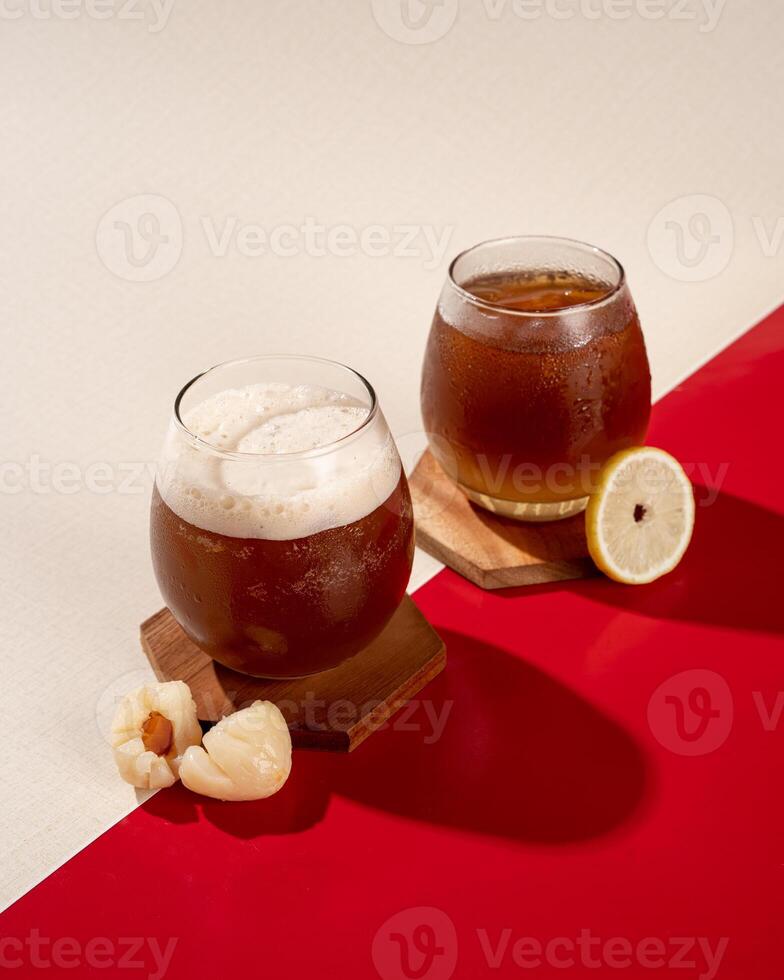 Iced tea is a tea drink that is served cold with ice cubes or you can add lychees photo