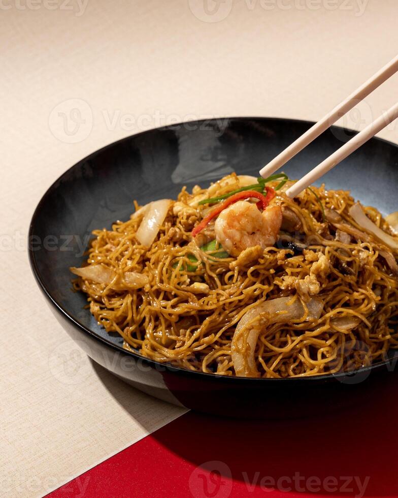 Asian rice noodles with shrimp and vegetables close-up on the table