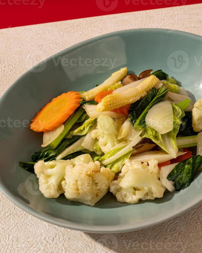 Capcai or capcay is the name of a typical Chinese-Indonesian dish in the form of many kinds of vegetables cooked by boiling or stir-frying. photo