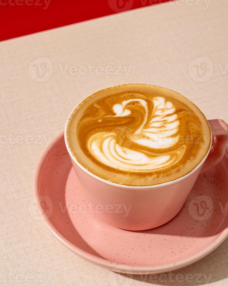 A cup of cappuccino coffee has the same ratio of espresso, steamed milk and foam photo