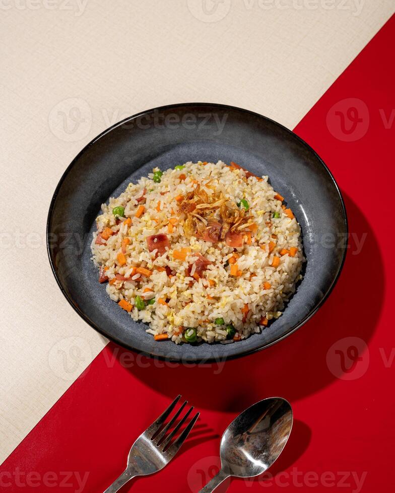 Fried rice is a dish of rice fried in a pan which produces a different taste because it is mixed with spices such as certain spices and sweet soy sauce. photo