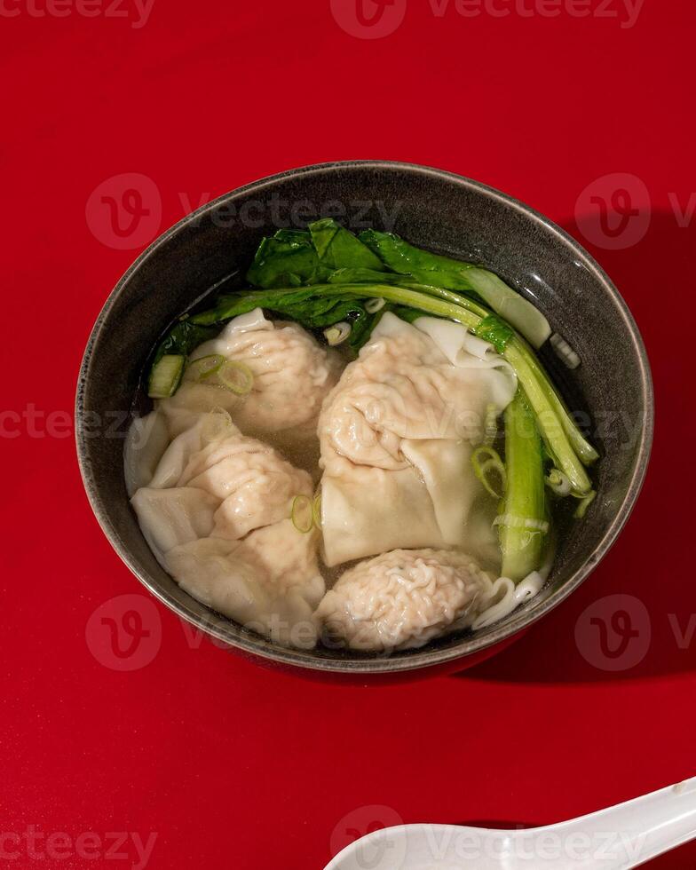 Wontons or dumplings are a soup dish containing pieces of meat and vegetables originating from China photo