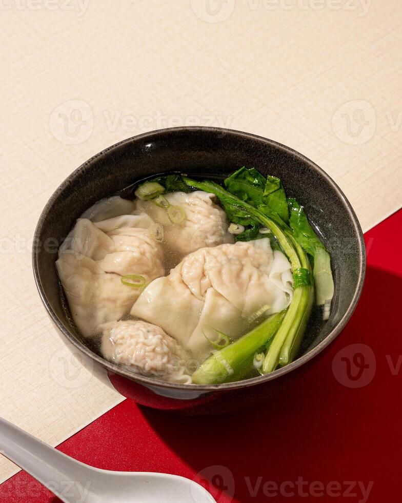 Wontons or dumplings are a soup dish containing pieces of meat and vegetables originating from China photo