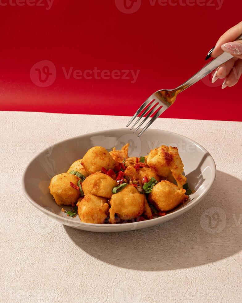 Salted chili tofu is a typical Indonesian food made from tofu which is fried and then given spicy chili seasoning photo