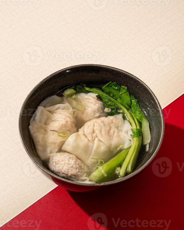 Wontons or dumplings are a soup dish containing pieces of meat and vegetables originating from China photo