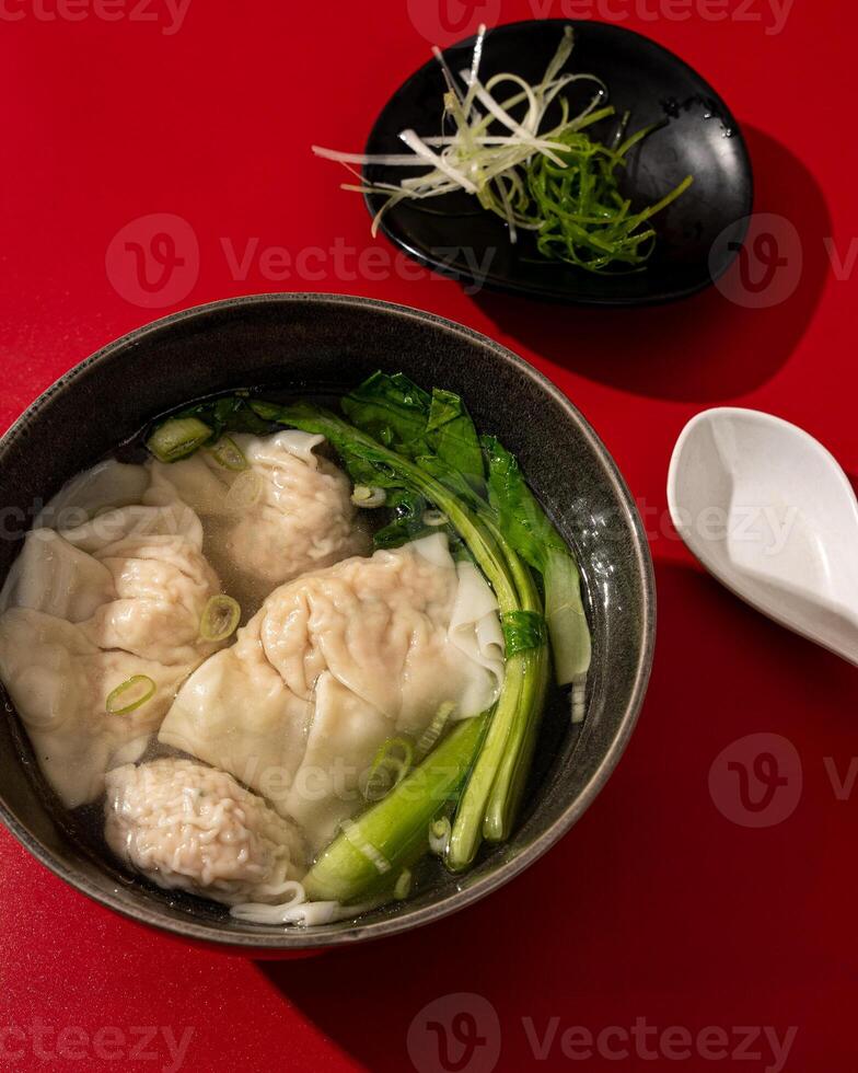 Wontons or dumplings are a soup dish containing pieces of meat and vegetables originating from China photo