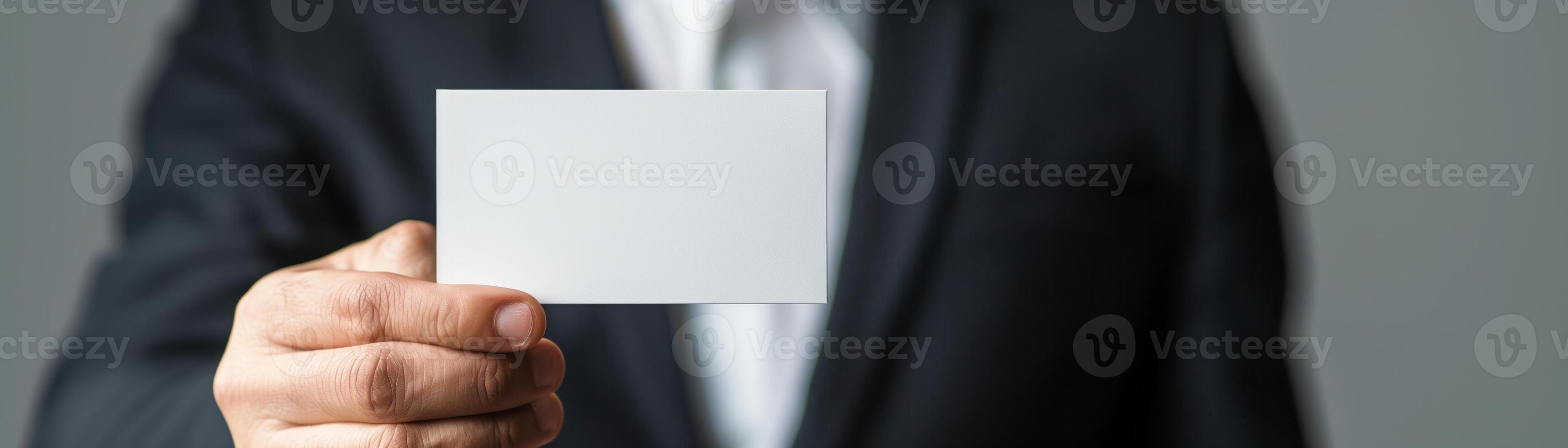 Businessman in suit holding blank business card, ready for customization. Perfect for corporate identity, business networking concepts. photo