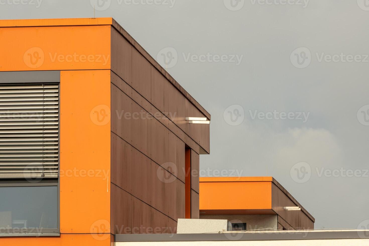 ultra modern office building with windows and orange walls photo