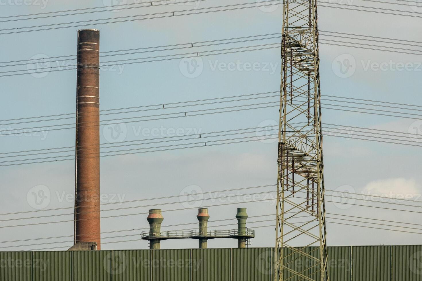 detailed view of an industrial building with high voltage power lines photo