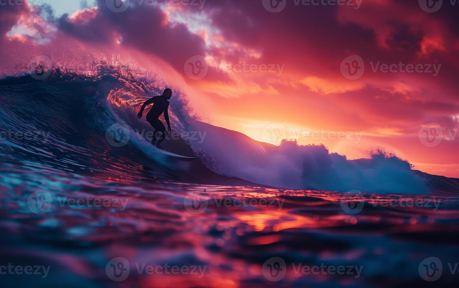 Silhouette of a surfer riding a wave at sunset with vibrant red and purple skies creating a dramatic and picturesque scene. photo
