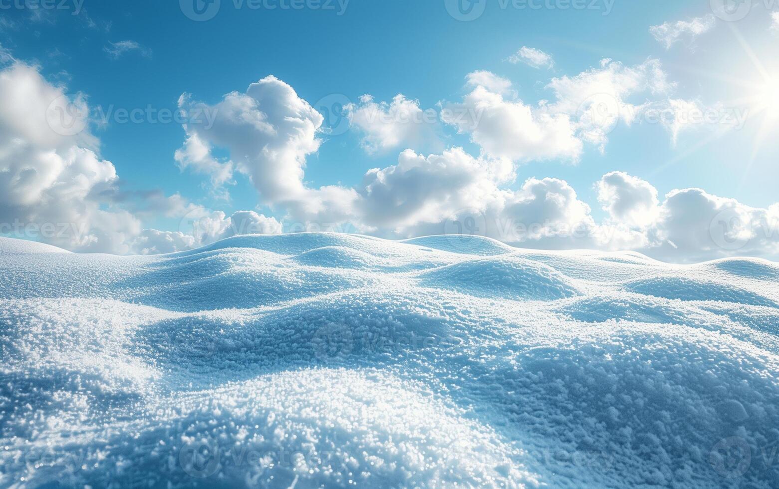 A serene winter landscape with snow-covered hills under a bright blue sky and white clouds, capturing the tranquil beauty of a snowy day. photo