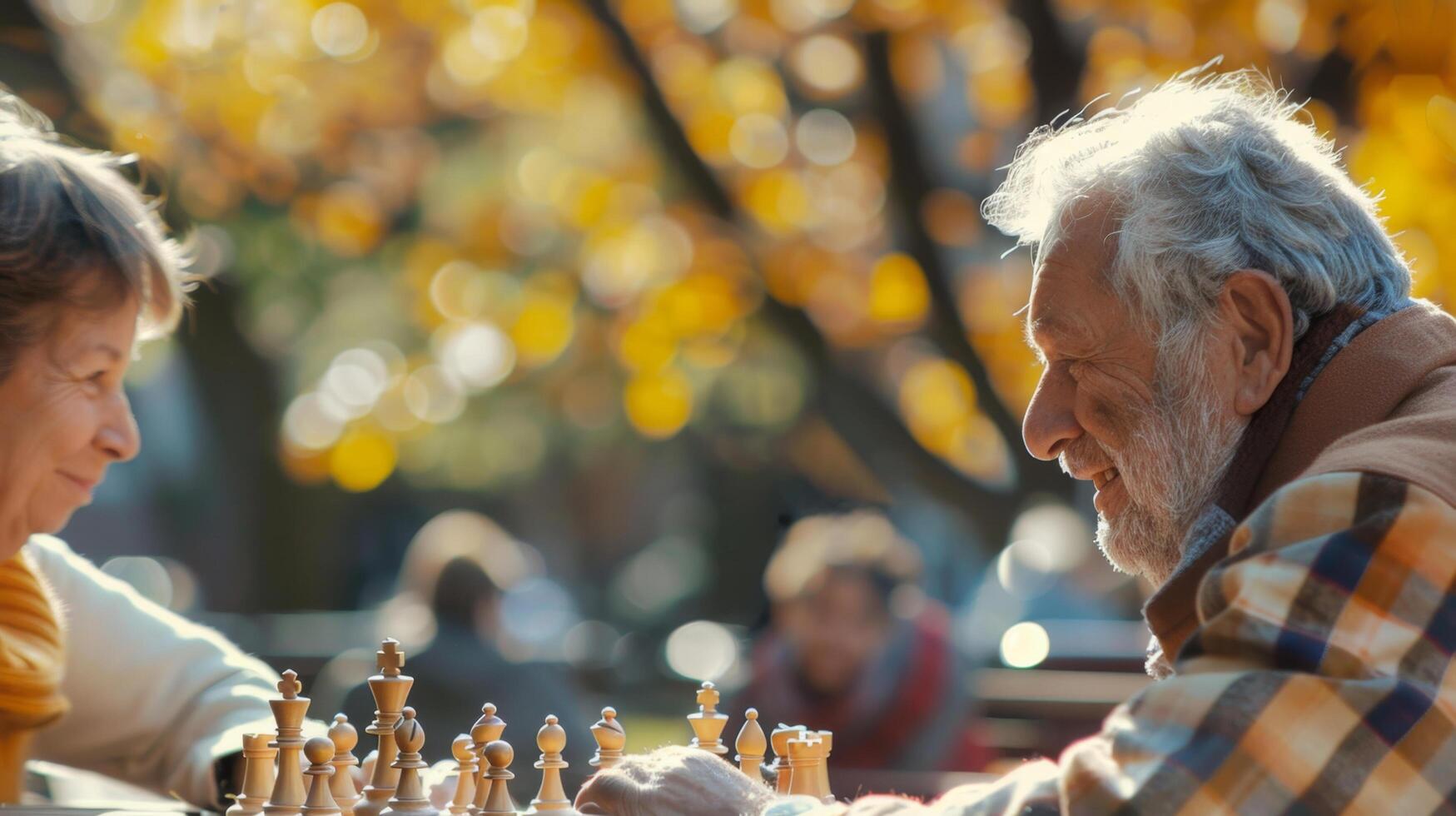 Elderly couple playing chess in a park during autumn, enjoying a sunny day filled with relaxation and strategy. photo
