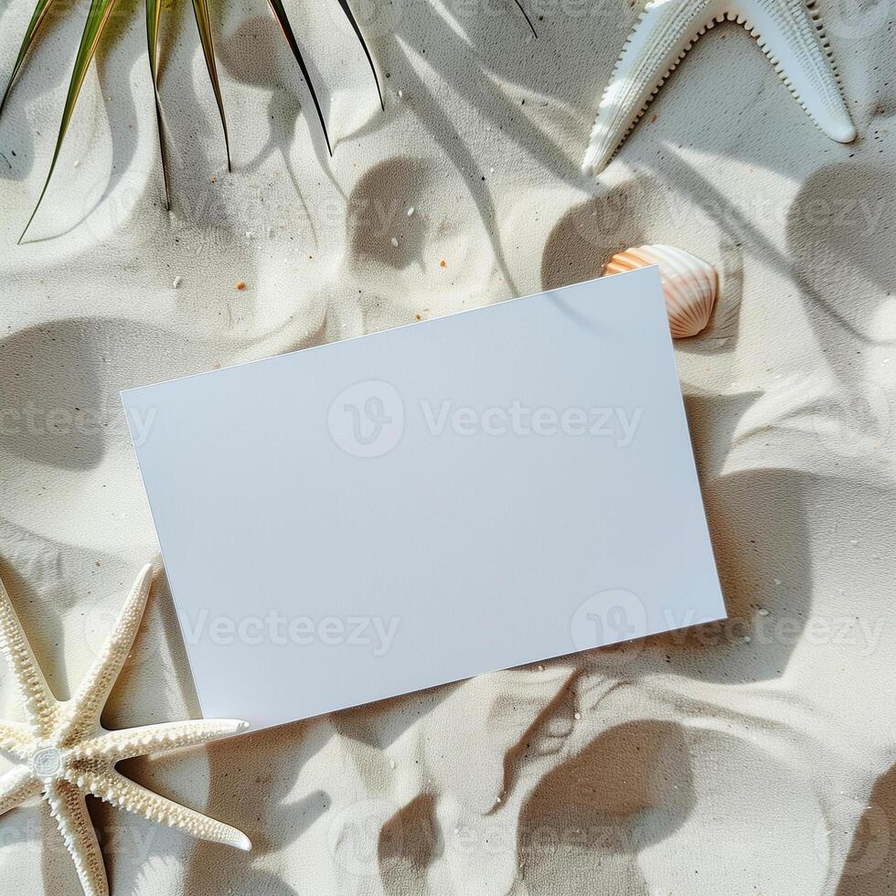 Blank paper on the sandy beach with seashells and starfish. photo