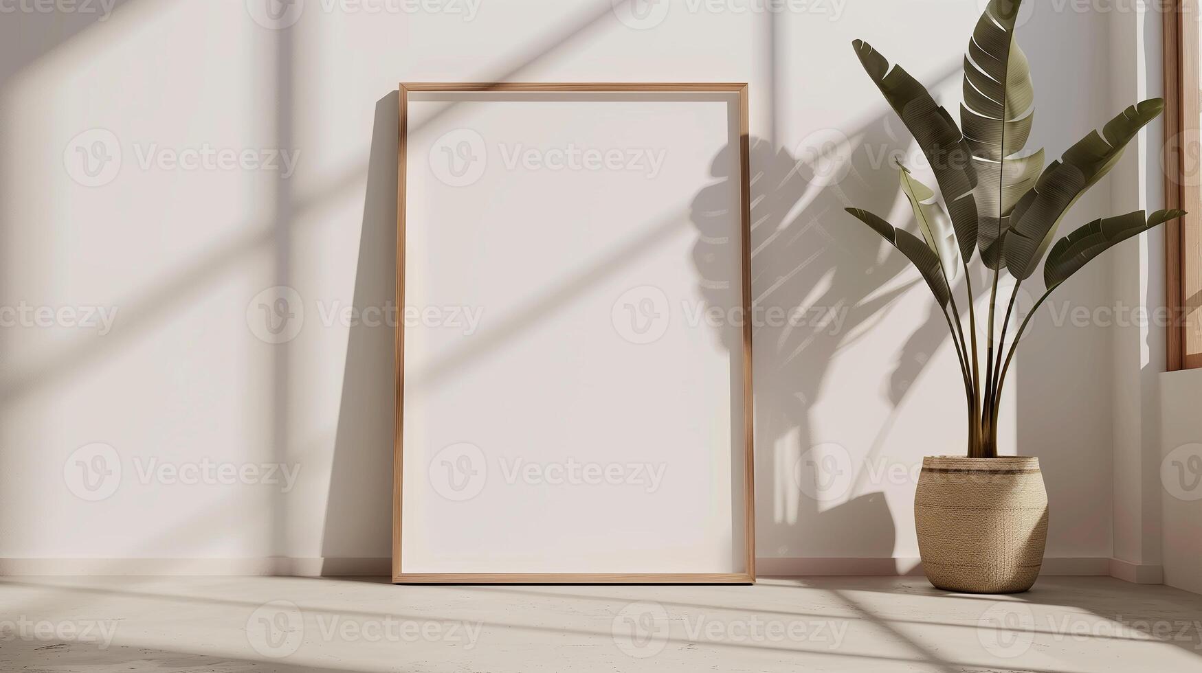 The wooden frame is placed on the floor, leaning against the wall. There is a potted plant next to it. The sunlight shines through the window, creating shadows on the wall. photo