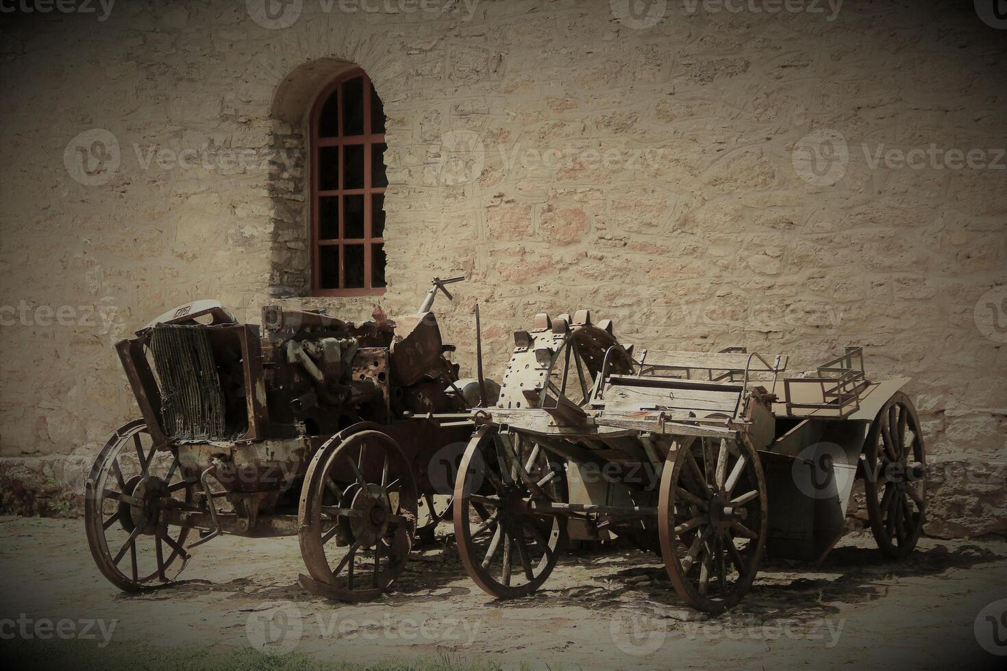 Two vintage carts standing near the ancient house photo