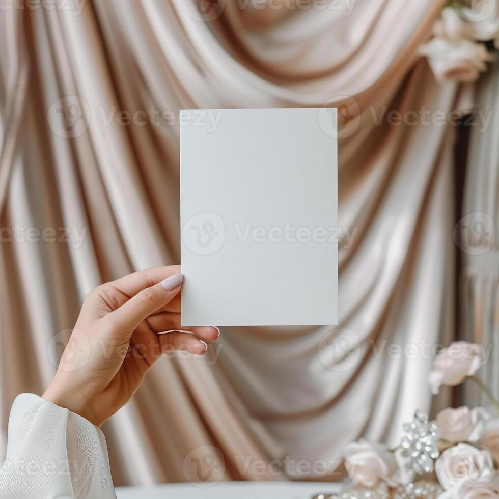 Blank paper in hand with roses and drapes in the background. photo
