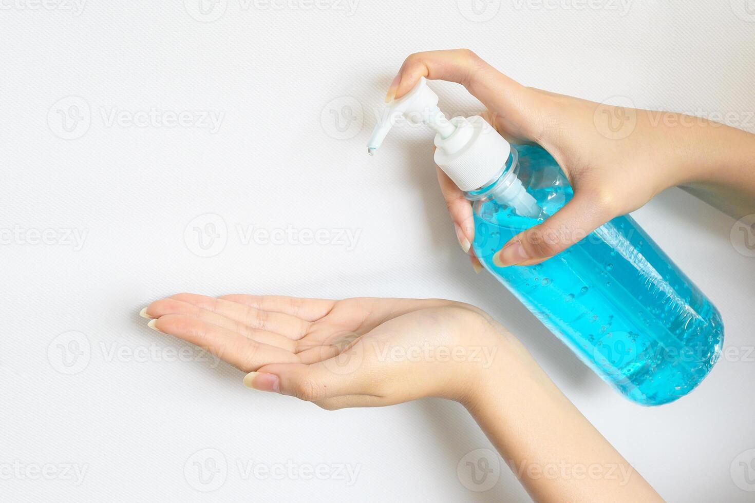 Cropped shot view of woman washing hand by hand sanitizer. photo