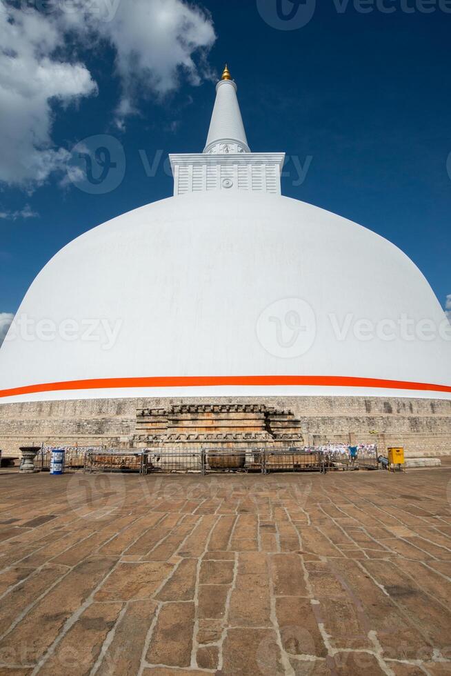 View of Ruwanwelisaya stupa in ancient city of Anuradhapura, Sri Lanka. Ruwanwelisaya stupa is one of the world's tallest ancient monuments and containing Buddha relics. photo