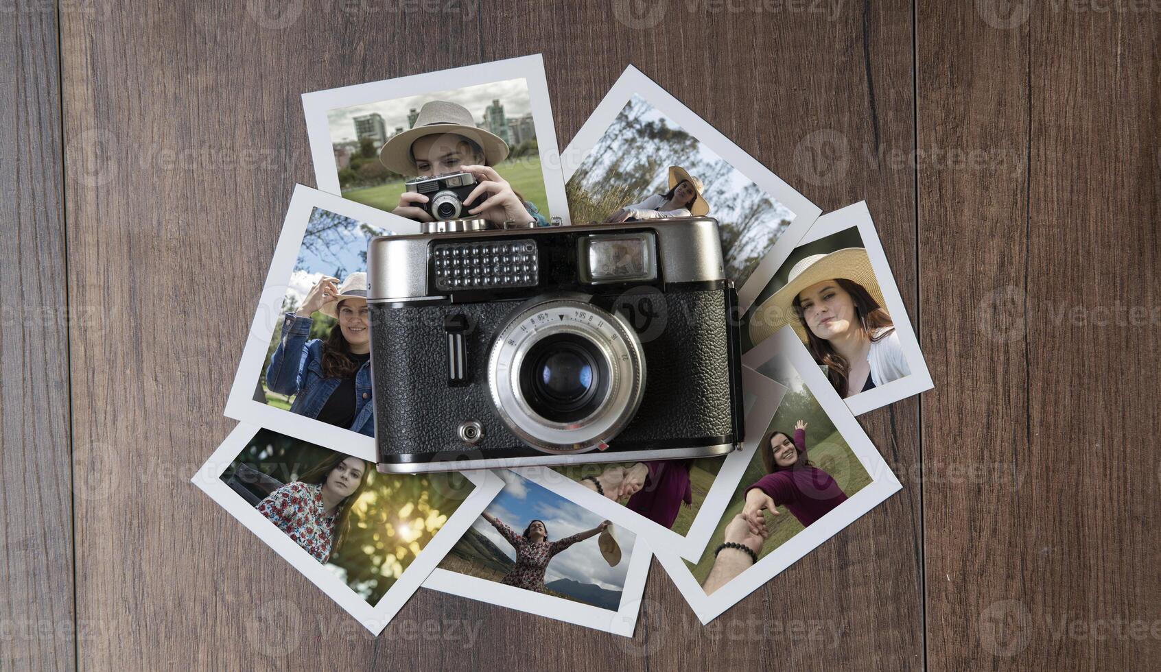 Old photo camera surrounded by photographs of women in different places on a dark wooden table