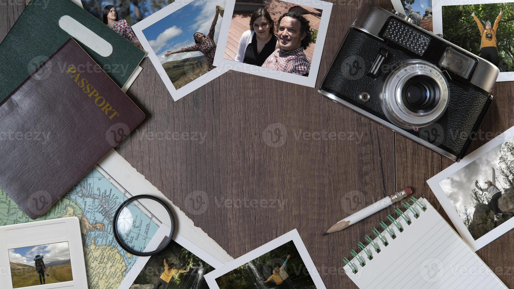 Couple photographs, passports, old camera, map and notebook on a dark wooden table photo