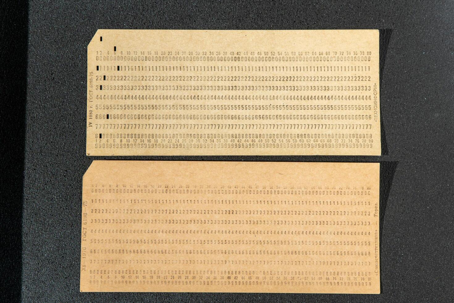 Punch card is a storage medium. Perforated cardboard, paper with holes to automate information, was used in the first old computers photo