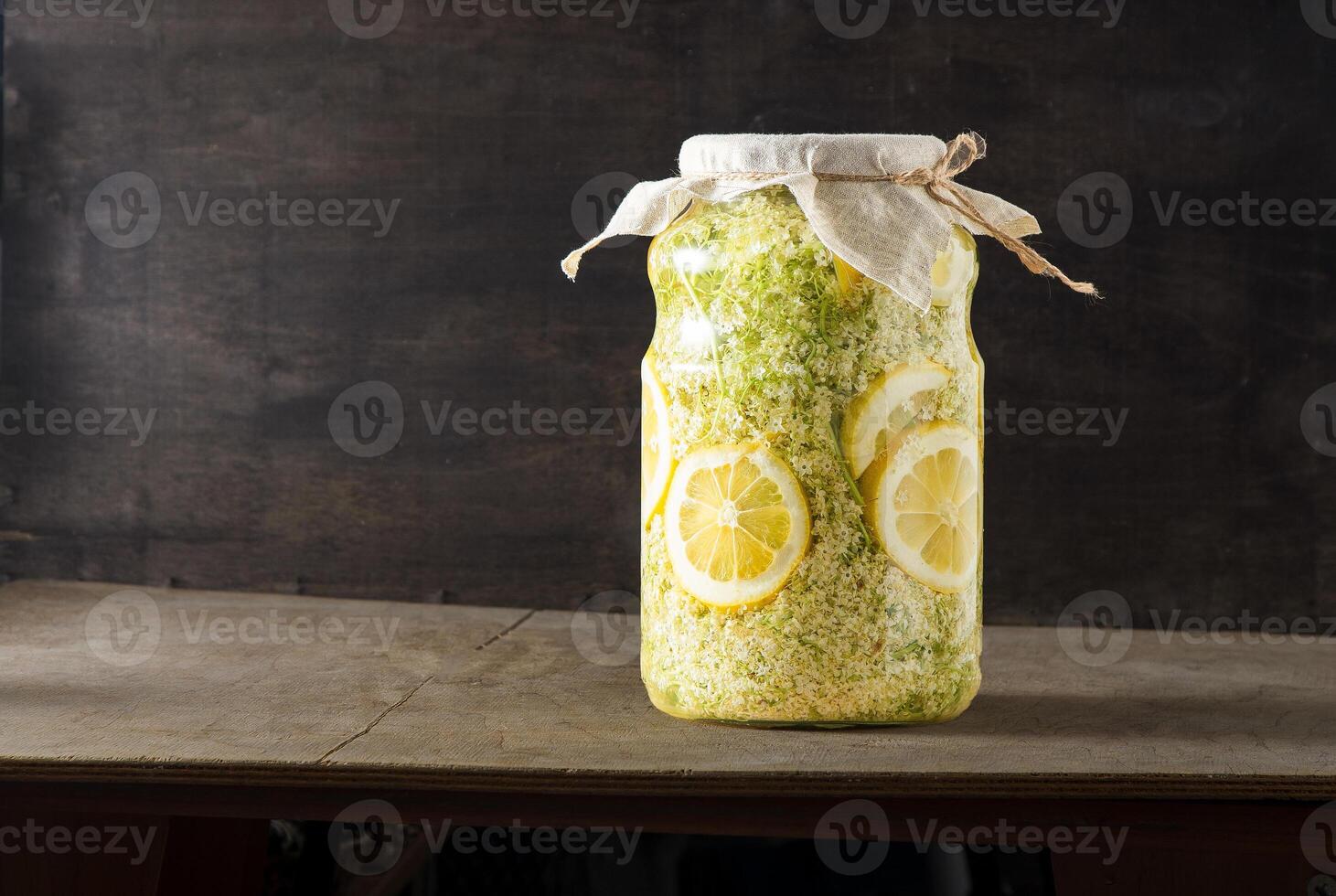 Elder flowers drink glass. White flower shrub. Harvesting buds for making syrup and drink. Cooking drinks. photo
