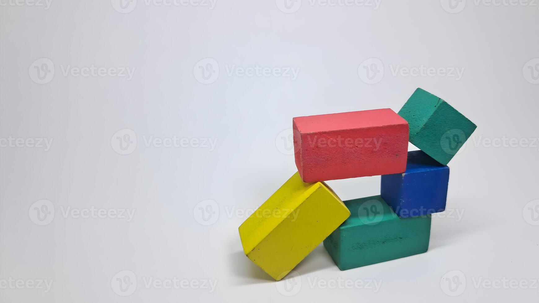 a pile of colorful blocks on a white surface photo