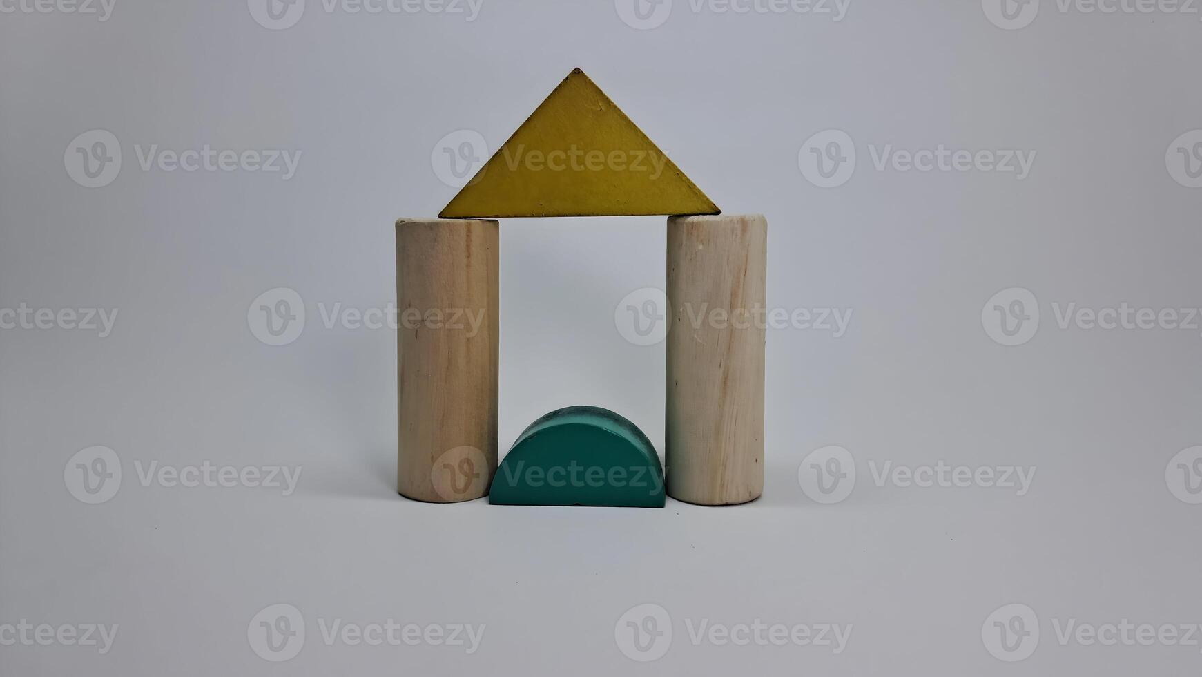 a wooden toy with a triangle and a green triangle photo