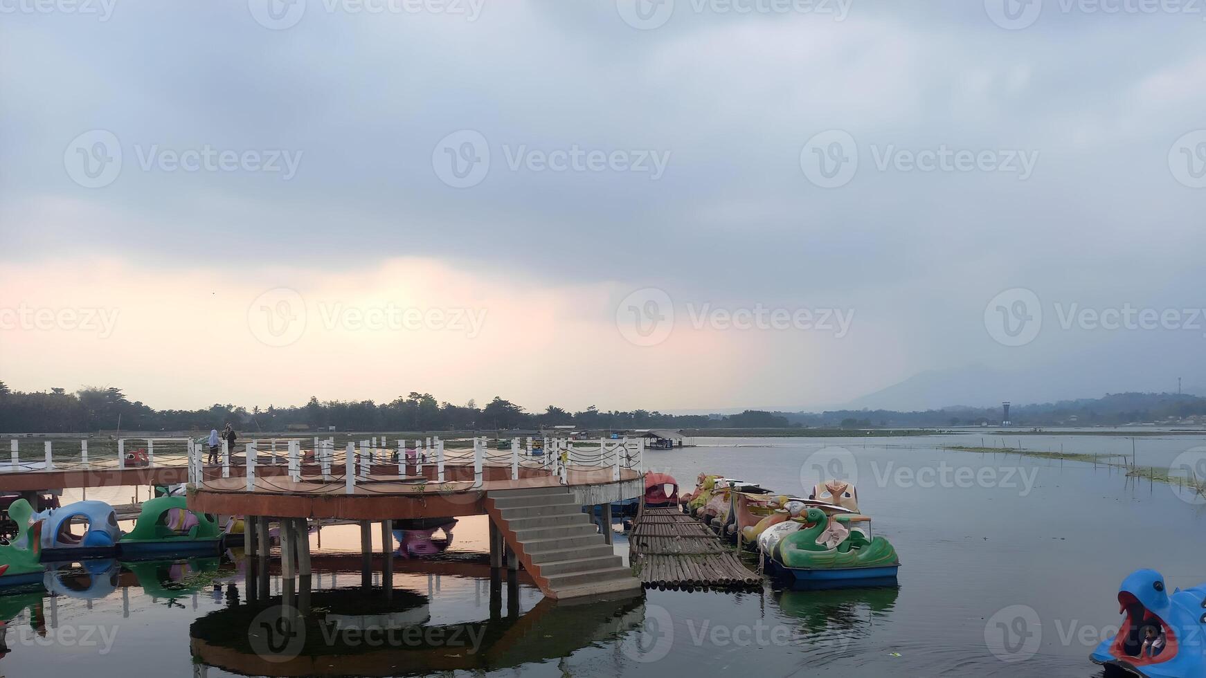 a lake with a dock and several boats in it photo