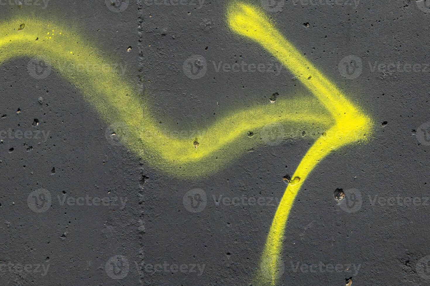 yellow line on a black surface that looks like an arrow photo