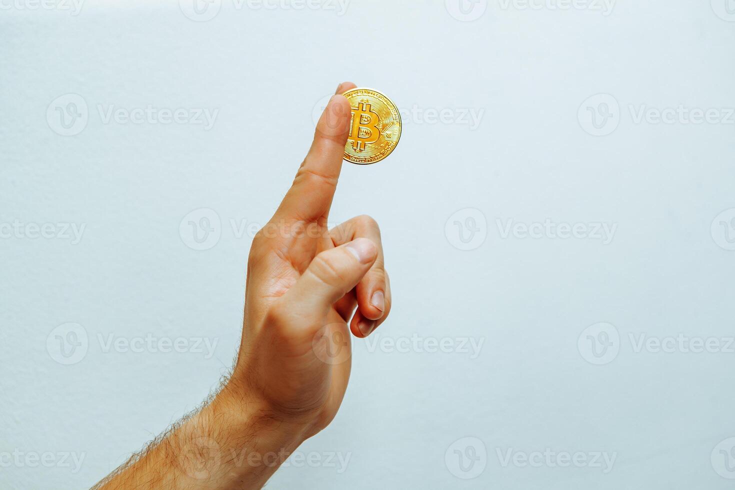 Man holding bitcoin in his hand. photo
