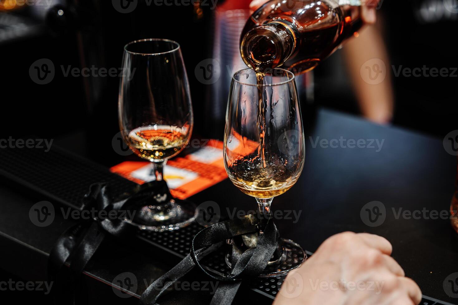 Bartender pours whiskey for tasting. photo
