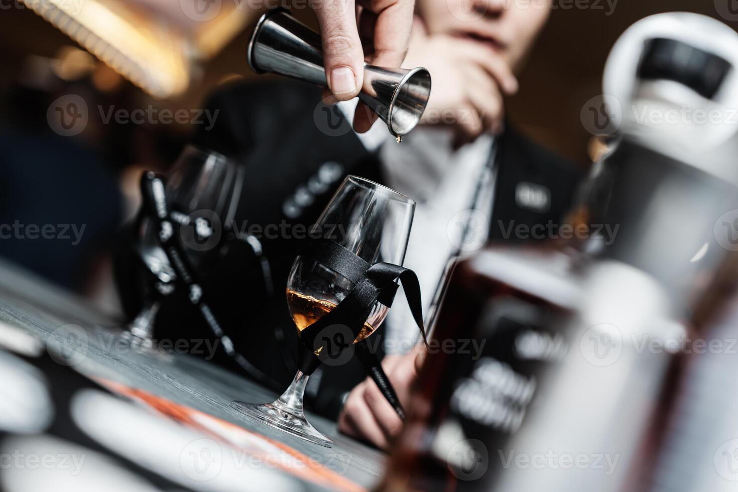 Bartender pours whiskey for tasting. photo