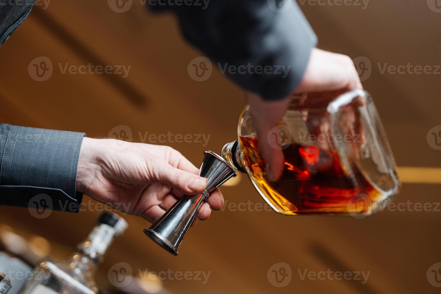 Bartender pours whiskey for tasting. photo