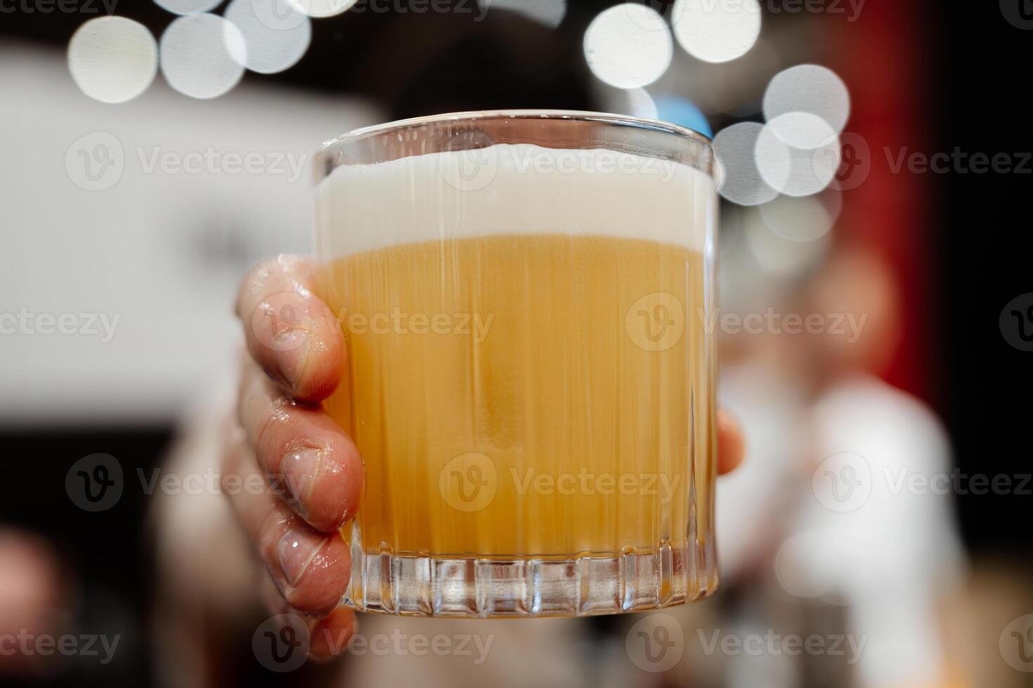 The bartender serves a yellow cocktail. Big plan. photo