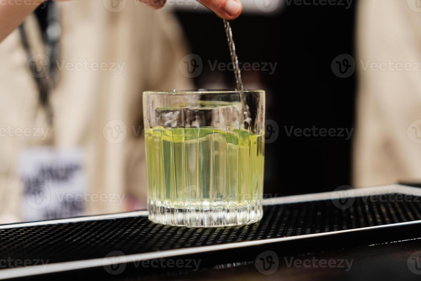 Preparation of a delicious cocktail based on gin and vodka. photo