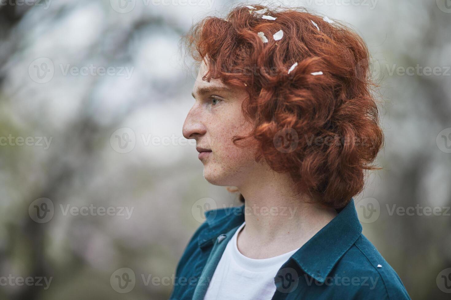 a young man with red hair and white flowers in his hair photo