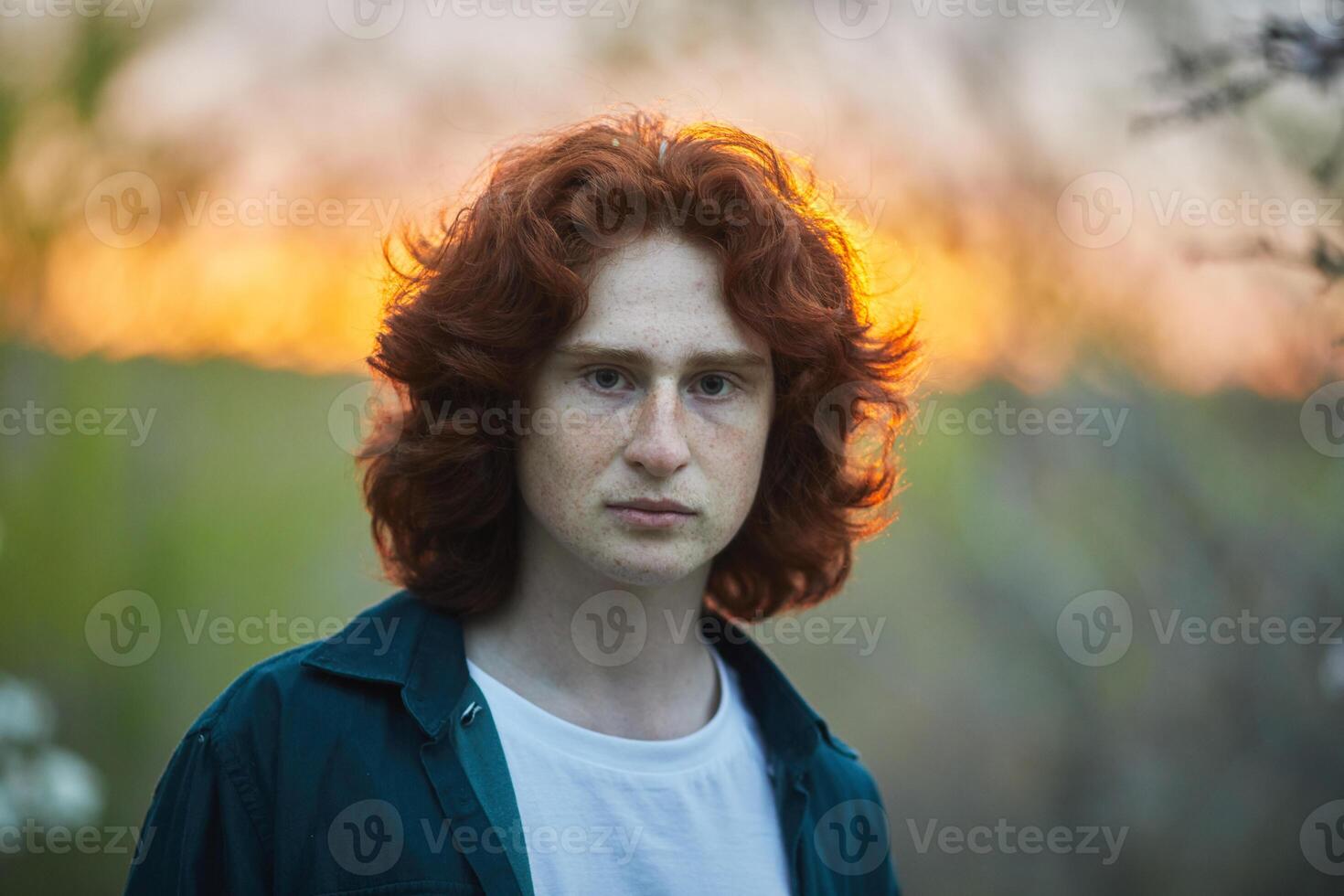 a man with red hair and a green shirt photo