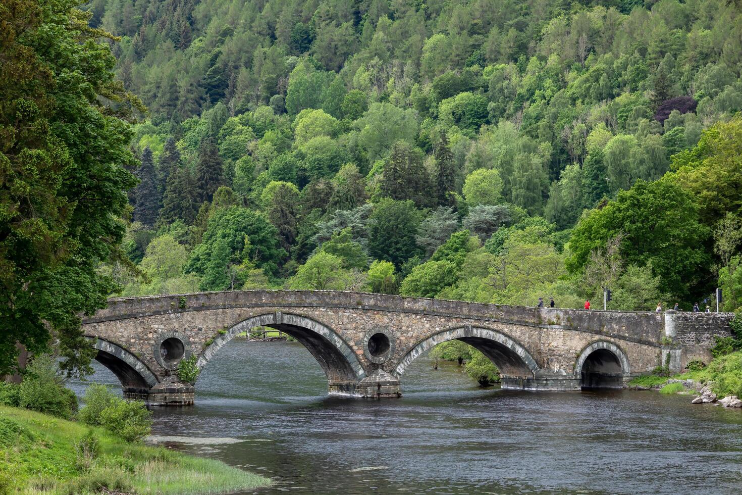 KENMORE PERTHSHIRE, SCOTLAND, UK, MAY 27. Old stone bridge in Kenmore Scotland on May 27, 2024. Unidentified people photo