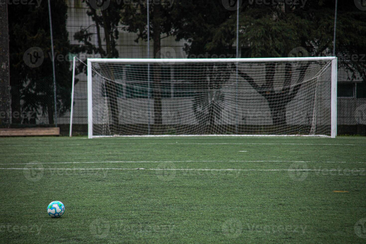 Soccer ball in front of goal post, ready for action. Dynamic sports imagery for your project. photo