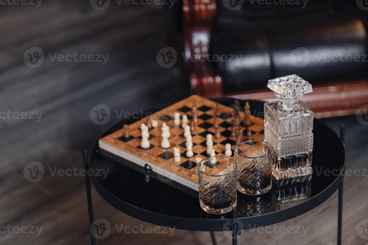 chessboard with chess and three cigars in the center on a wooden background photo