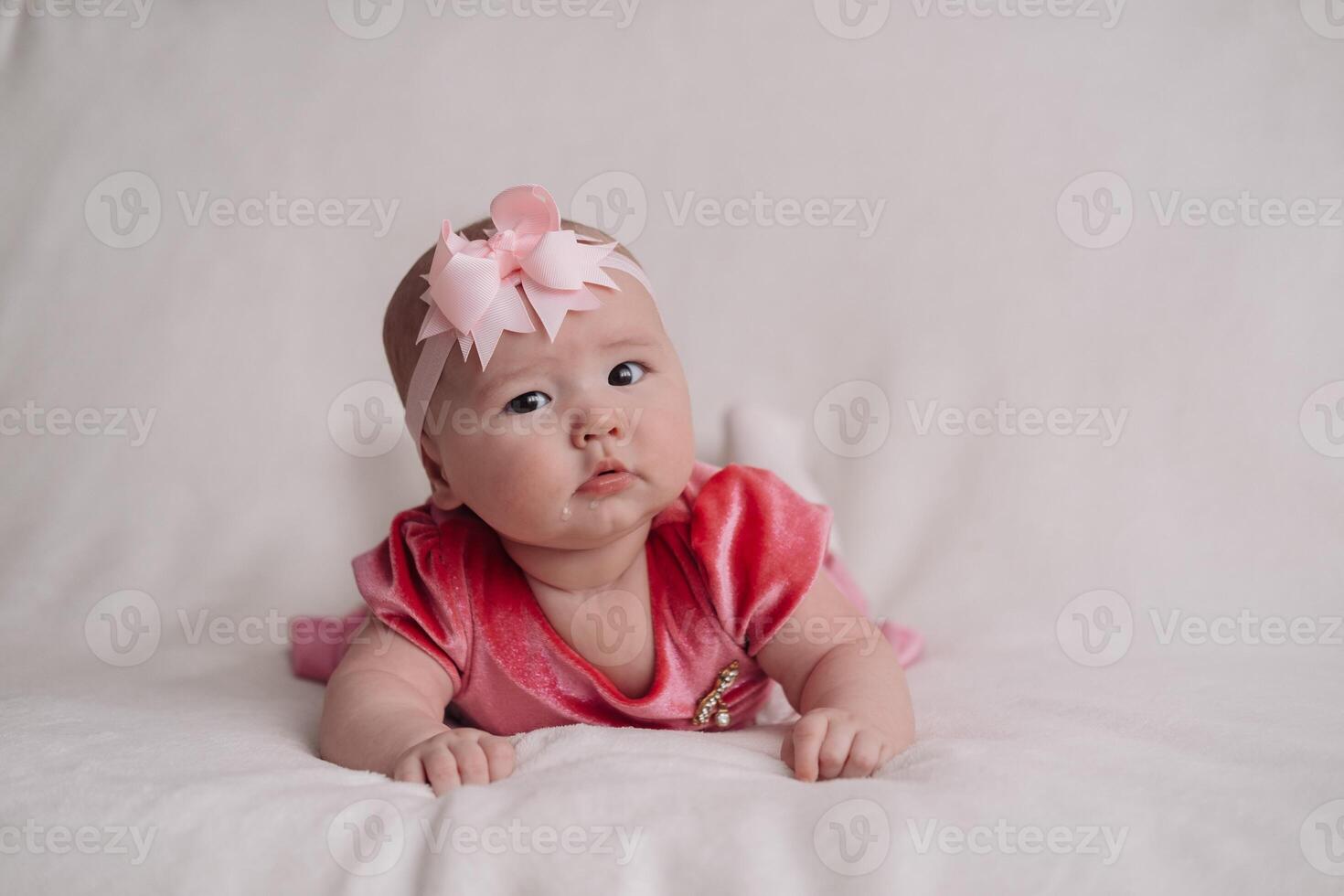 a child under one year old, lying on a white background photo