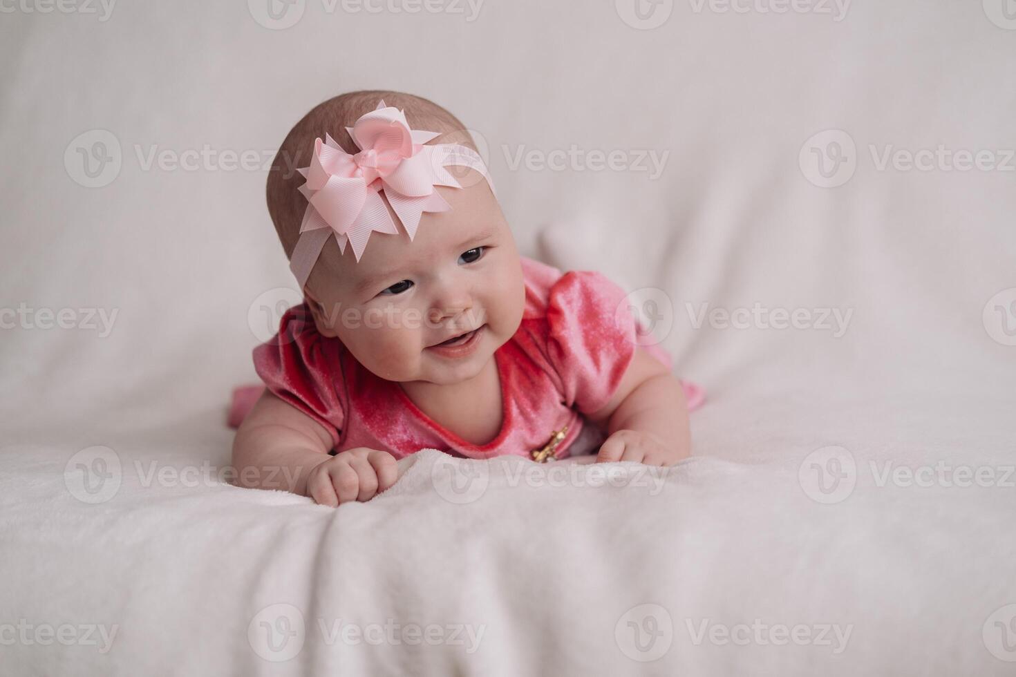 a child under one year old, lying on a white background photo