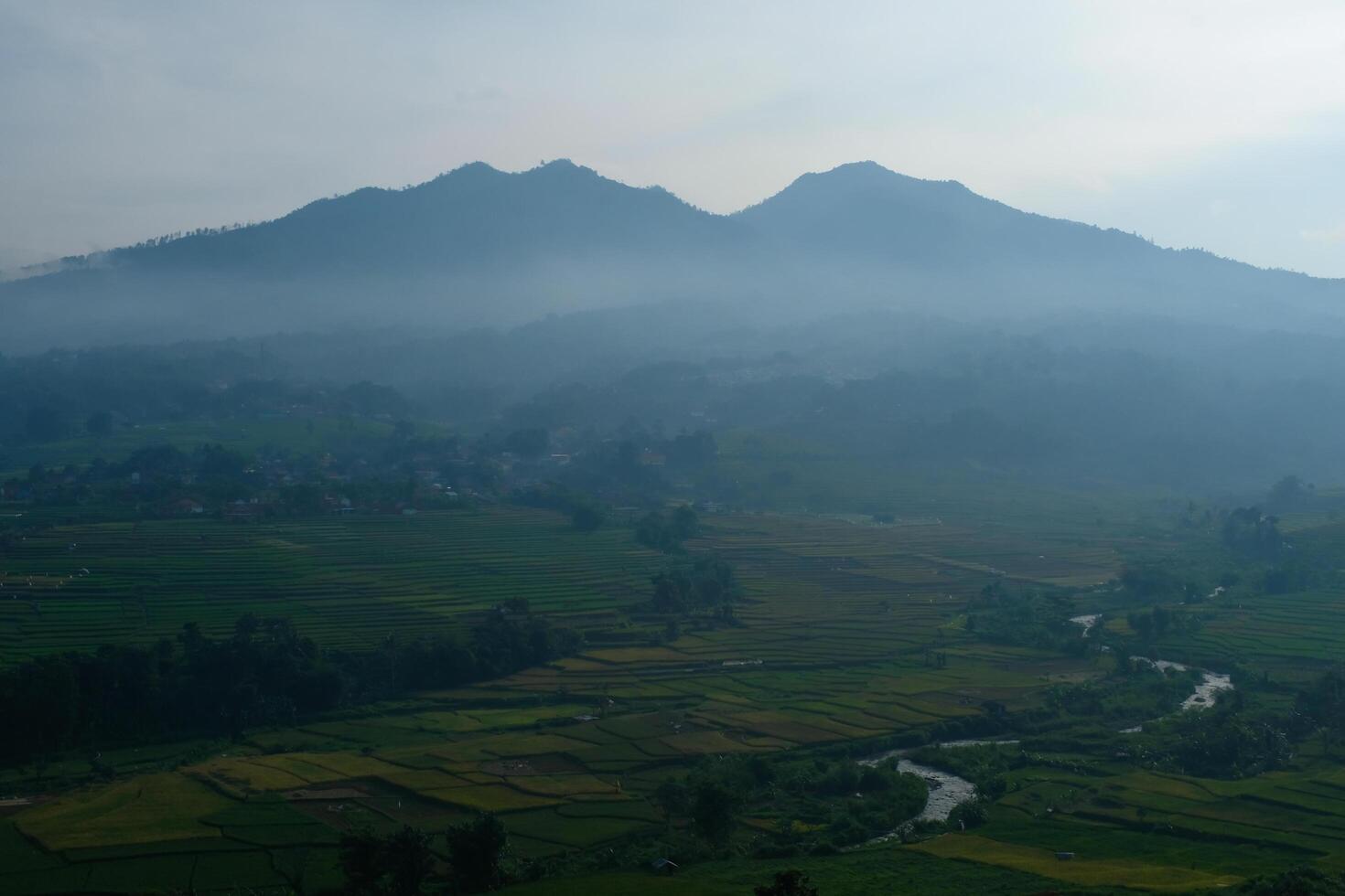The silhouette of Mount Manglayang when the weather is foggy. Textured Background of Mountains. Graphic Resources. Industry Agricultural Photography. Panoramic landscape. Nature Photography Concept. photo