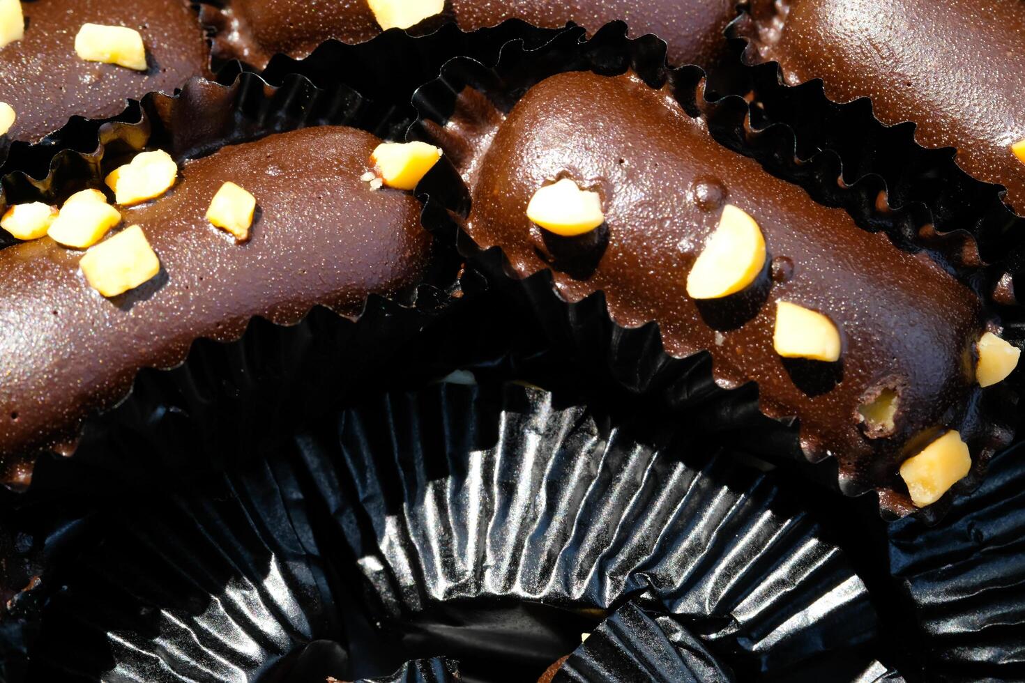 Photography of Chocolate Cookies wrapped in black paper background. Textured Detail of cookies in the jar. Graphic Resources. Food Photography. Cookies and pastries. Food Photography Concept. photo