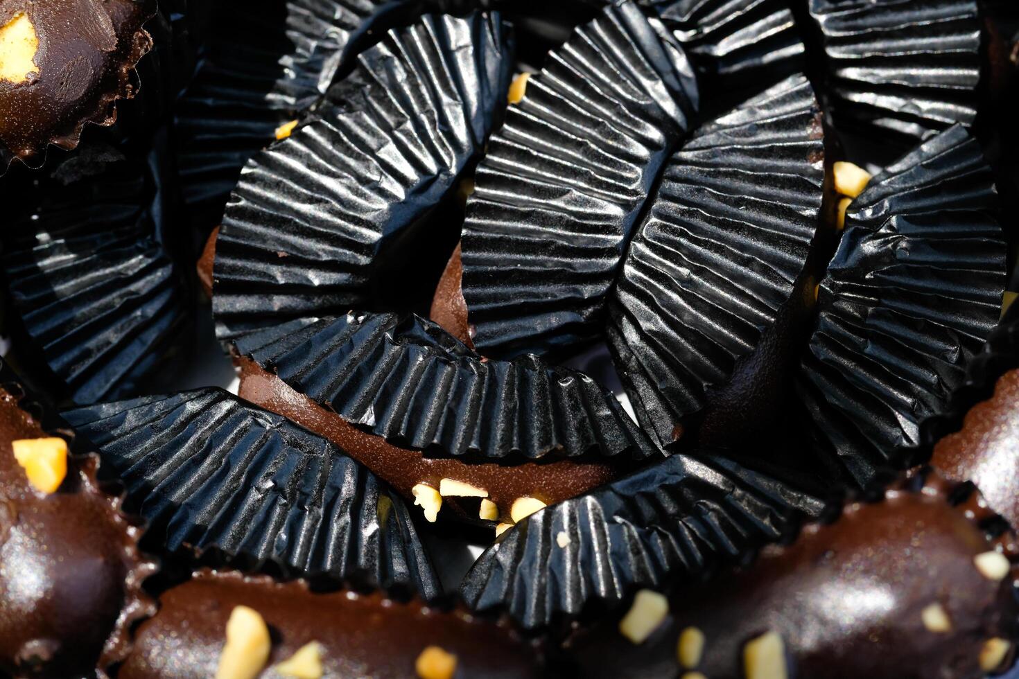 Photography of Chocolate Cookies wrapped in black paper background. Textured Detail of cookies in the jar. Graphic Resources. Food Photography. Cookies and pastries. Food Photography Concept. photo