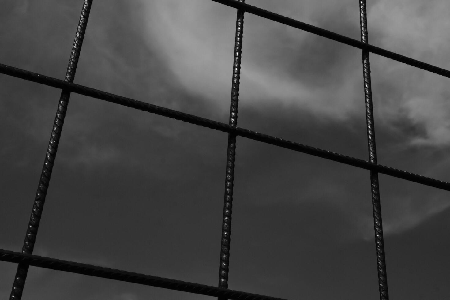 Black and white iron fence with rectangular weave. Monochrome of exterior on public park. Graphic Resources. Monochrome Background Photography. Light Shadow Photography Concept. photo