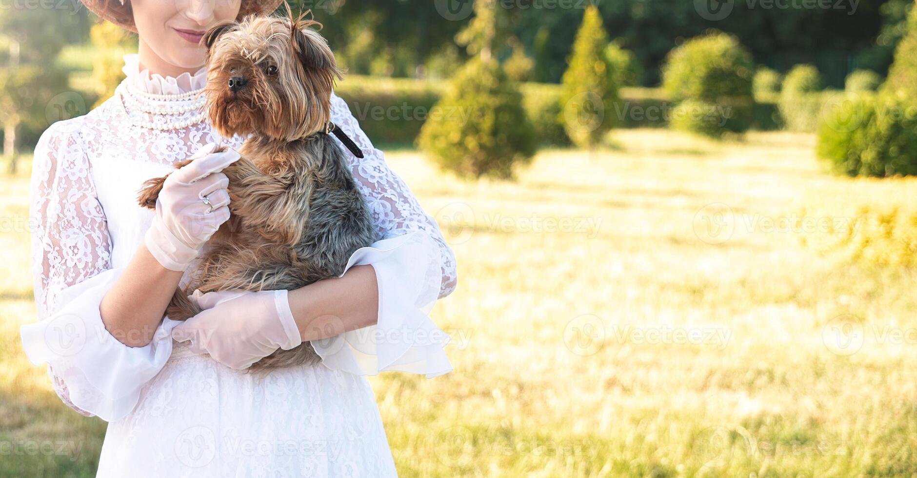 Retro portrait of a beautiful woman holding Yorkshire terrier.retro photo