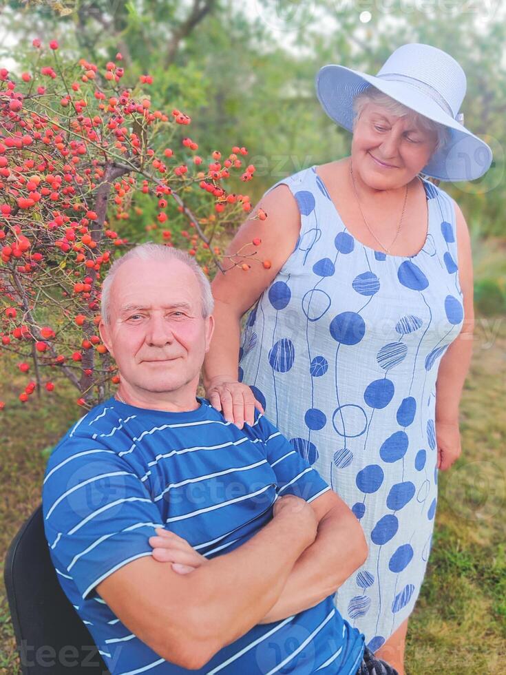 Happy senior couple enjoying each other in the park. Support and care from a loved one, warm emotions photo