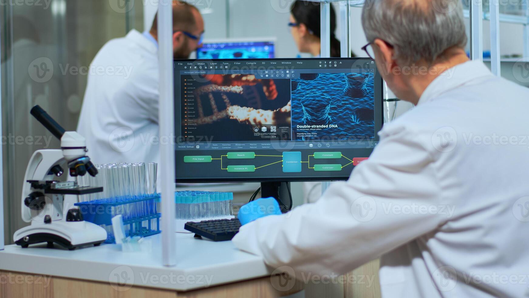 Scientist in lab coat working at a computer in modern equipped laboratory. Multiethnic team examining vaccine evolution using high tech and chemistry tools for scientific research, virus development photo